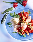 Close-up of cod fillet with tomatoes, vegetables and rice on plate