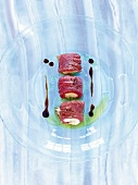 Tuna sashimi stuffed with creme fraiche on glass plate