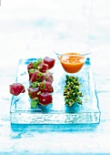 Marinated tuna with egg yolk dip, capers and spring onions on plate