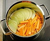 Close-up of sliced carrots and turnips in pot
