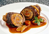 Close-up of beef roulades with papaya and sauerkraut filling on plate
