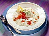 Cod fillet with dill sauce on plate