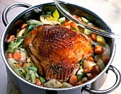 Turkey thigh with vegetables, cream sauce and apples in pot