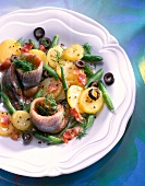 Potato and bean salad with soused herring on plate