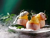 Three orange sorbet served in hollowed-out oranges on plate