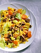 Rice with lamb, carrots, celery and onions on plate