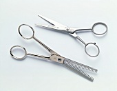 Two different types of scissors on white background