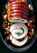 Veal roulade with spinach and tomatoes cut in slices, overhead view