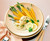 Carrots with peanut sauce and lemon slices on plate