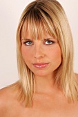 Portrait of skeptical looking grey eyed woman with shoulder length blonde hair and fringes