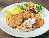 Celery Burger in nut crust with salad and yoghurt sauce on plate
