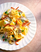 Ribbon pasta with peppers and mushroom sauce on plate