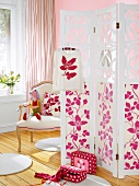 Room with folding screen with pink floral print, chair