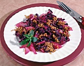 Red cabbage with pears, oats and peppermint leaves on plate