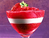 Glass of rhubarb and vanilla cream with strawberries, close-up