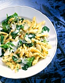 Noodles with spinach and cheese on plate