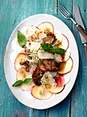 Apple, radish and carpaccio with fillet on plate