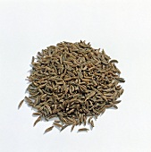 Close-up of cumin seeds on white background