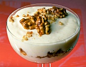 Yogurt cream with honey and walnuts in glass
