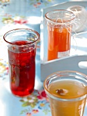 Three glasses filled with different flavoured jelly in it