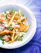 Close-up of potato noodles with carrots in bowl