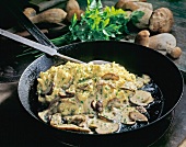 Scrambled eggs with parsley and porcini mushrooms in pan