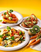Close-up of vegetable curry rice, fruit salad in papaya, ham sandwich, kiwi and carrots