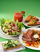 Close-up of fried potatoes with roasted beef, salad, sandwiches and tomato juice