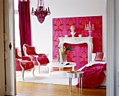 Living room decorated in white and pink with chair, sofa and carpet