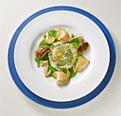 Herb ravioli with ceps and parsley on plate