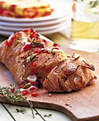 Close-up of ciabatta filled with tomato and mozzarella on chopping board