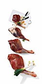 Meat of red moose, wild deer and fallow deer on cutting board and on white background