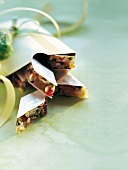 Close-up of crunchy diamond shaped sweets with almonds and pistachios
