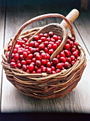 Close-up of cranberries in basket with wooden scoop in it