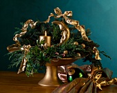 Advent wreath with golden candle, crescent and loops on table