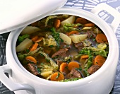 Close-up of beef soup with savoy cabbage and potatoes in serving dish