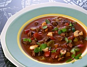 Close-up of beef soup with mushrooms and pepper on plate