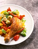 Chicken leg with sweet and sour vegetables on plate