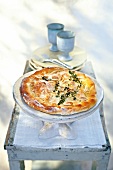 Pie cake with olive oil, almonds and sprigs of thyme in serving dish