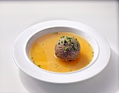Liver and spleen dumplings in soup on plate