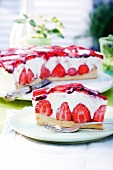Slice of strawberry cream cake on plate