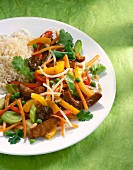 Rice with mu-err mushrooms, carrots, peppers and leeks on plate