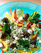 Close-up of pepper salad with meatballs and rice on plate