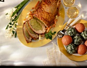 Stuffed breast of veal and tomato with spinach dumplings on plate