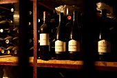 Wine bottles on wooden shelf in Beaumont Winery, South Africa
