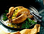 Roasted chicken stuffed with coconut rice on plate
