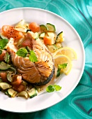 Close-up of marinated salmon steak with vegetables on plate