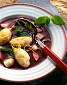 Close-up of elderberry soup with semolina dumplings on plate