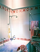 Bathroom with red and white tiles and bubble in bathtub