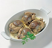 Roasted quail with liver stuffing in baking dish